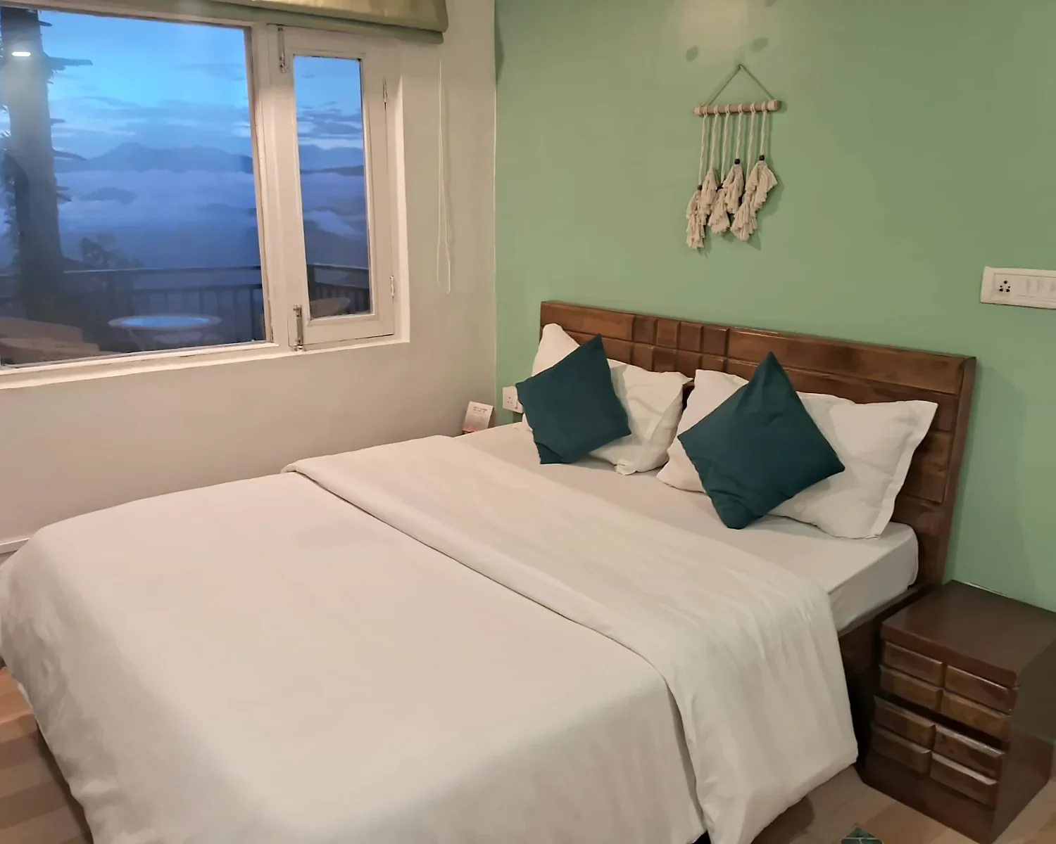 Fireside Retreat with sage-green walls and a king bed