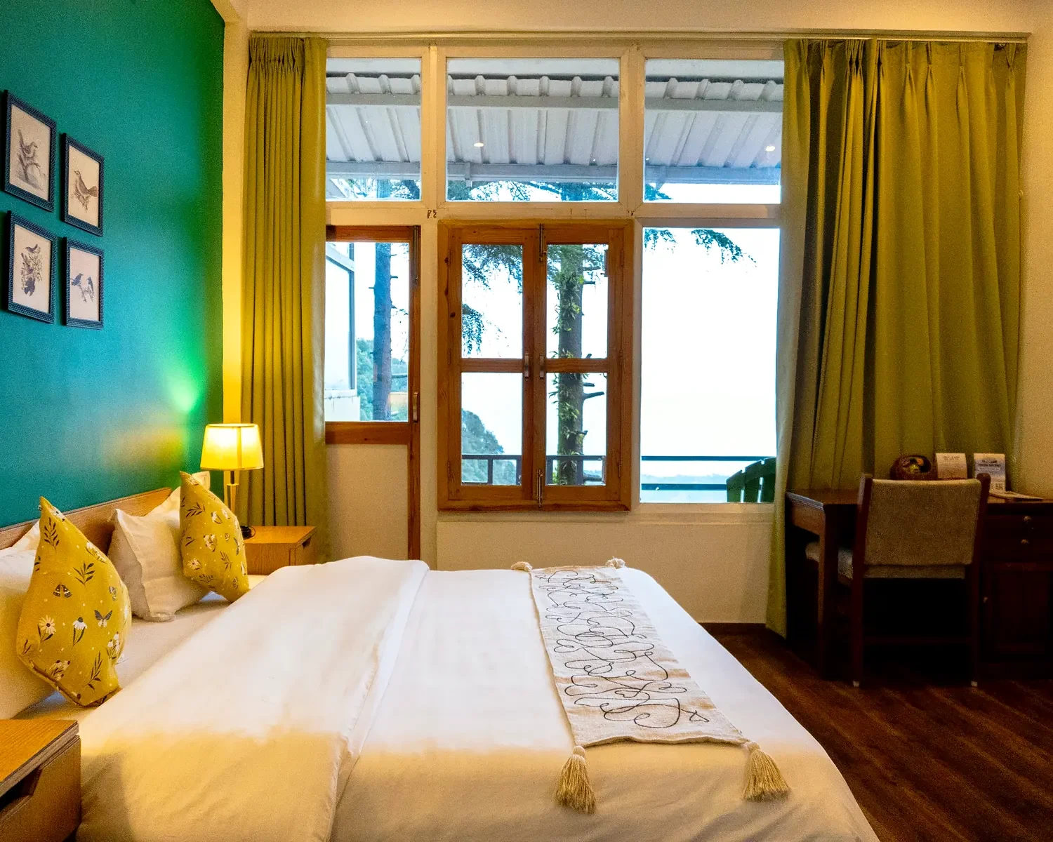 Peak View Perch room with an emerald wall and tall windows